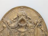 a gold plate with a picture of a man and a woman on it