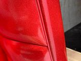 a close up of a red umbrella on a stand