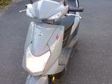 a scooter that is parked on the side of the road