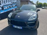 the black porsche cayen is parked on the side of the road