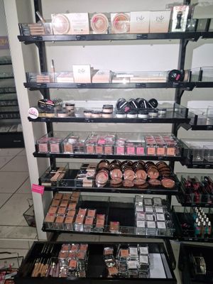 a lot of makeup products on the shelves in the store