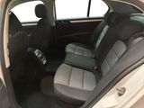 the interior of a car with the door open showing the front seats