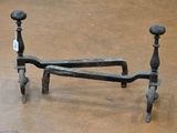 wrought iron bed frame with turned legs and foot rests on the floor