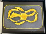 painting of a yellow ribbon in a black frame on a white surface