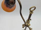 an old fashioned lamp on a white surface with a white background