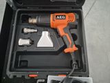 an orange and black electric drill in a black case