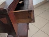 a wooden table with a drawer on top of it