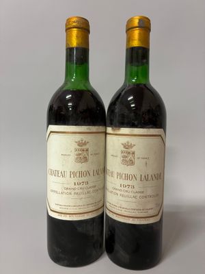 two bottles of wine sitting next to each other on a table