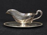 a silver plate with a saucer and saucer on it