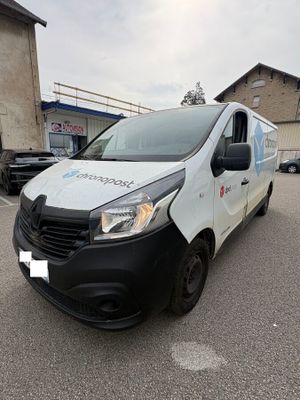 a white van parked in a parking lot next to a building