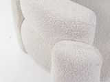 a white teddy bear sitting on top of a white chair