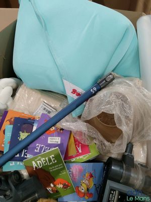 a box full of toys and books and a blue umbrella