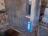 an image of a stainless steel ice maker in a basement