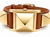 an image of a brown leather bracelet with gold pyramids on it