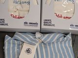two boxes of blue and white striped shirts are on a table