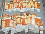 a lot of orange and white cards in a box