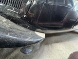 a close up of an old car with a denting on the front of it