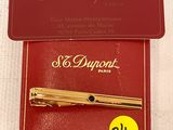 a red box with a gold tie bar in it