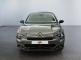 the front view of a grey car in a white room
