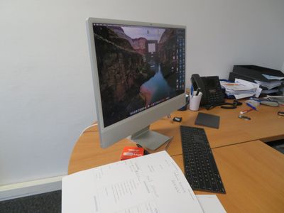 a computer monitor sitting on a desk next to a keyboard and mouse
