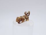 an image of a gold elephant figurine sitting on top of a white pedestal