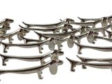 a lot of silver dog shaped dishes on a white table
