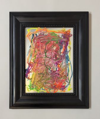 abstract painting in a black frame hanging on a wall