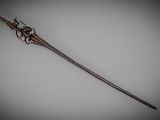 a close up of a metal stick on a white surface