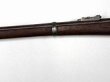 a rifle mounted on a wall in a room
