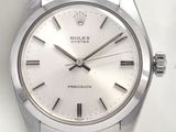 a watch that is sitting on a white surface