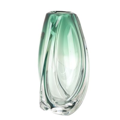a green glass vase that is sitting on a white surface