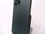 a green iphone that is sitting on a stand