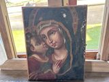 tableau représentant la Vierge à l'Enfant sur un chevalet en bois devant une fenêtre