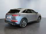 the rear end of a silver suv parked in a room