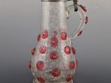 an image of a glass pitcher with red roses on it