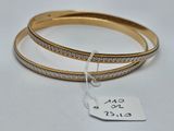 two gold and silver bang bracelets with a price tag