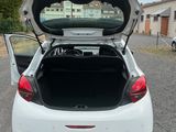the back of a white car with its trunk open in a parking lot