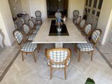 a long table with many chairs around it in a room