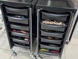 two black plastic drawers are stacked on top of each other