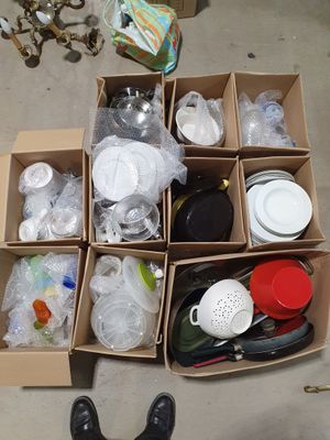 a cardboard box filled with assorted items on the floor
