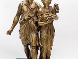 an image of a bronze statue of two women holding flowers