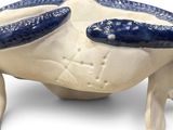 a blue and white crab sitting on top of a white bowl