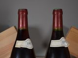 two bottles of wine sitting next to each other on a table