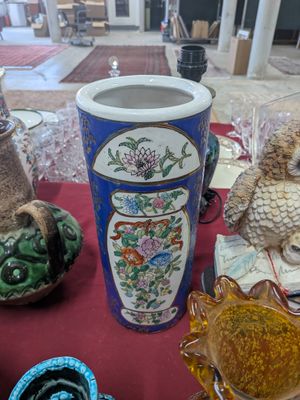 many vases on a table with a red table cloth