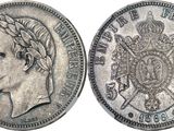 a silver coin with a crown on the front and a crown on the back