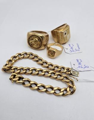 a group of gold rings and bracelets on a white surface