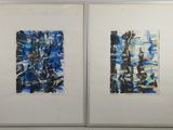 two framed paintings of blue and black abstract shapes on a white wall