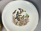 three plates that have birds on them on them