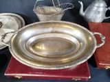a silver plate sitting on top of a table next to a teapot