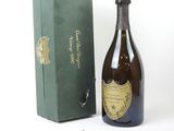 une bouteille de champagne posée à côté d'une boîte verte